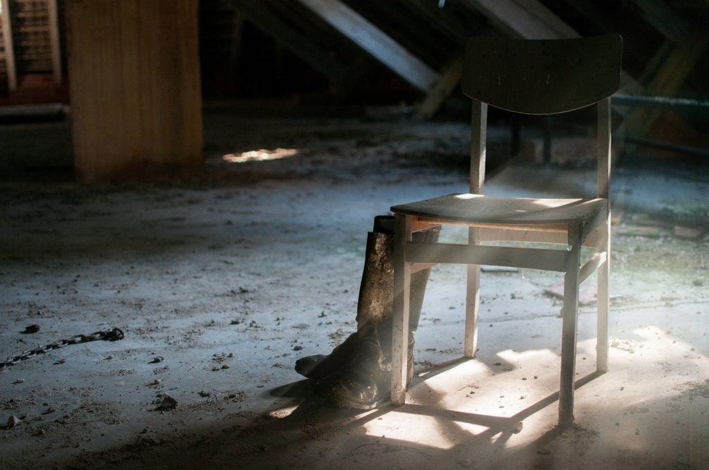 Chair and Boots Inside an Abandoned Home