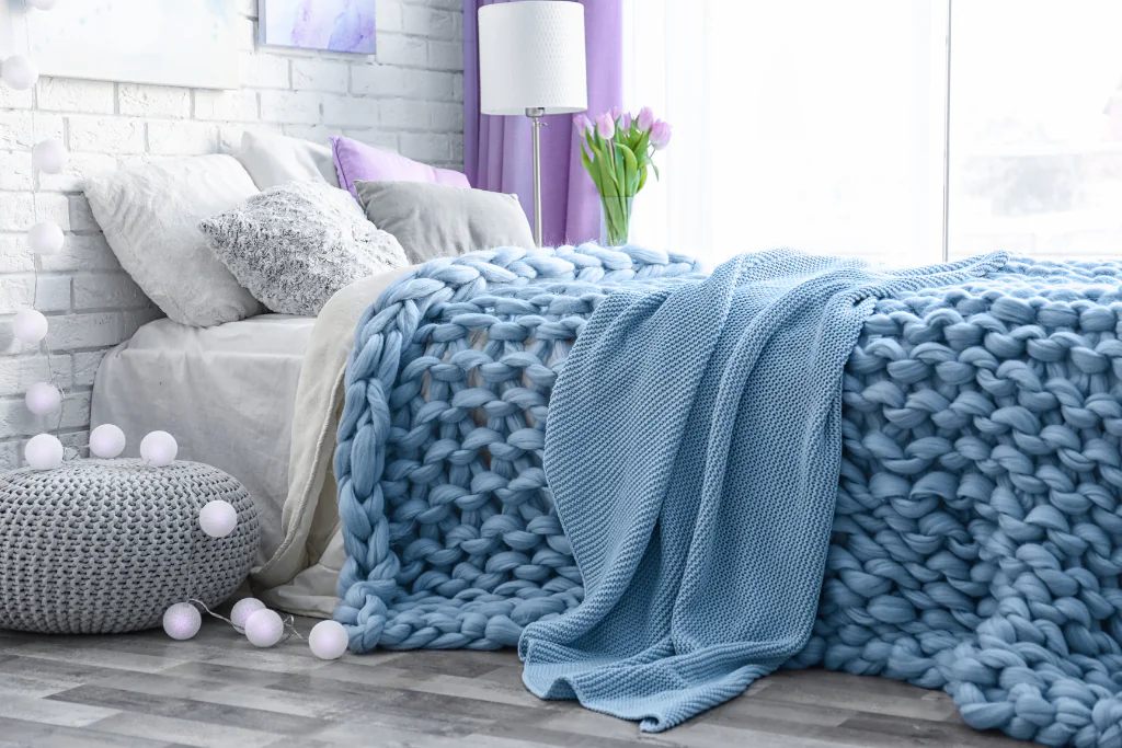A Cozy Blue and Grey Bedroom with a Chunky Knit Blanket
