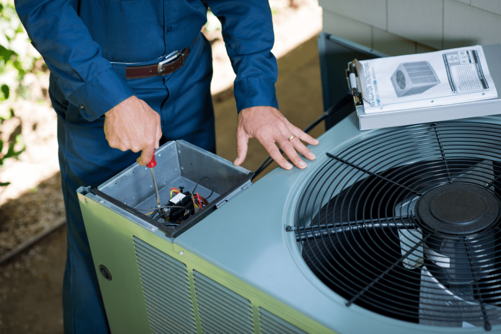 Man repairing a central air conditioning unit