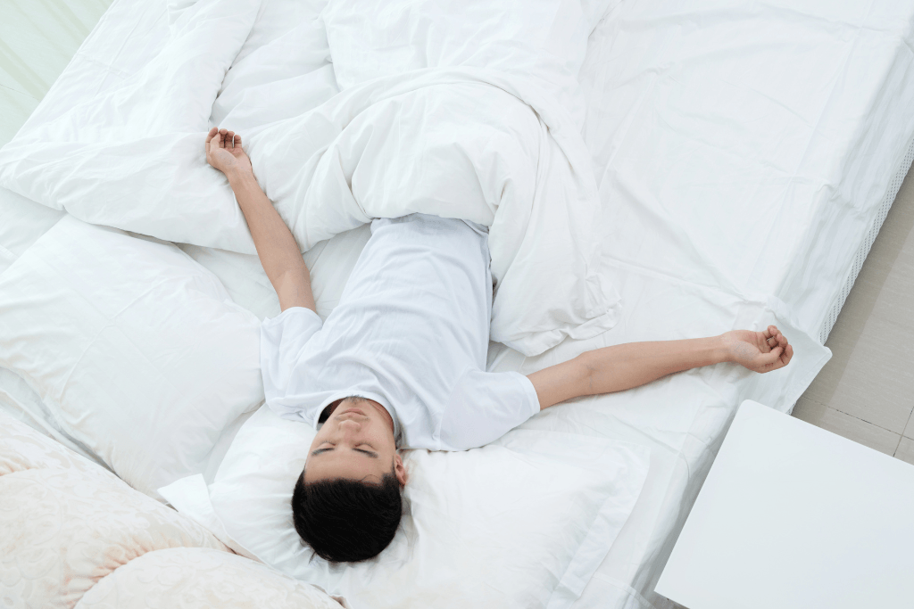 man in starfish sleeping position